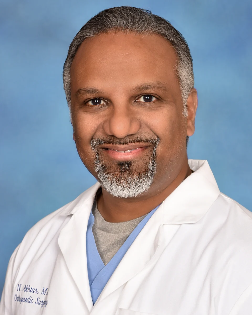Portrait of Dr. Nauman Akhtar in a white coat